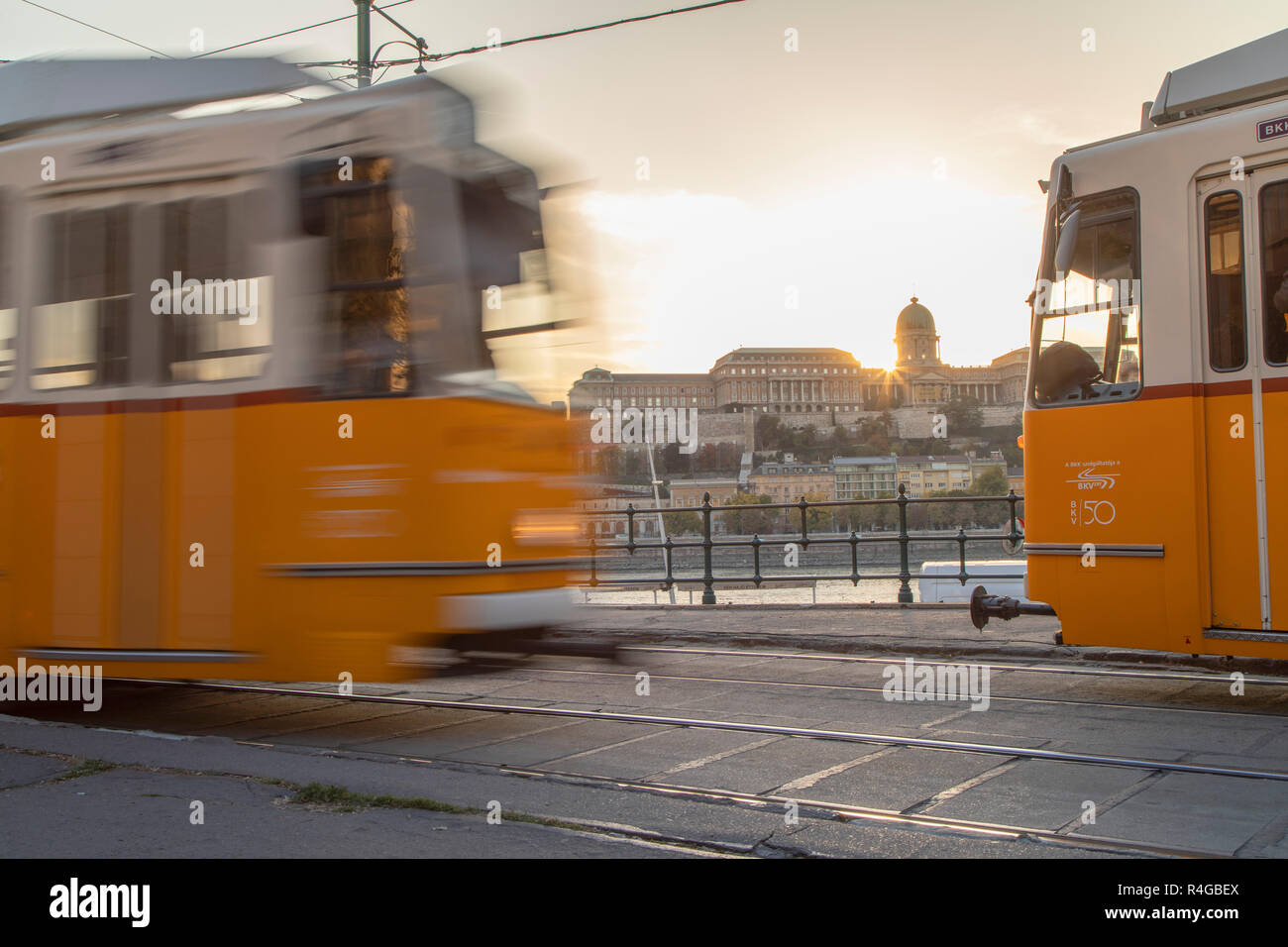 Trams on Danube Promenade with Buda Castle in background, Budapest, Hungary Stock Photo