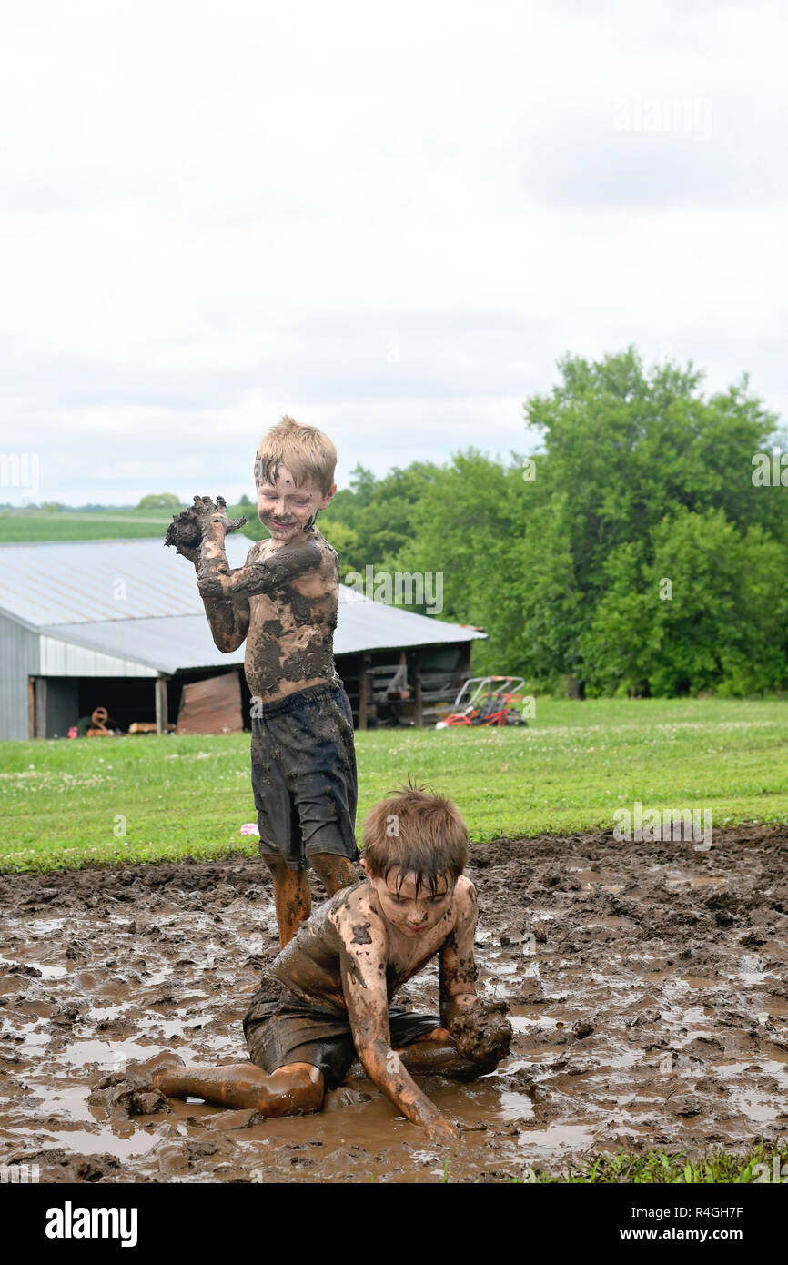 Little Boys Playing In Mud