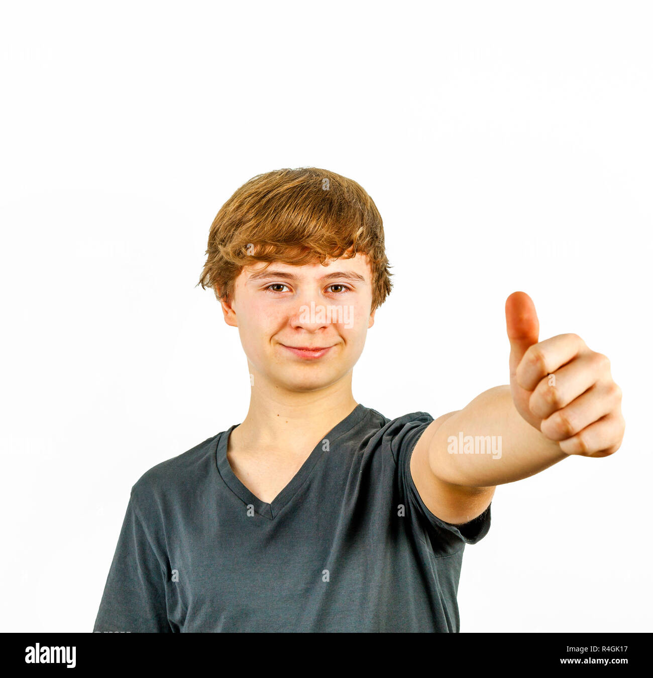 Teenage boy smiling showing thumbs up sign Stock Photo - Alamy