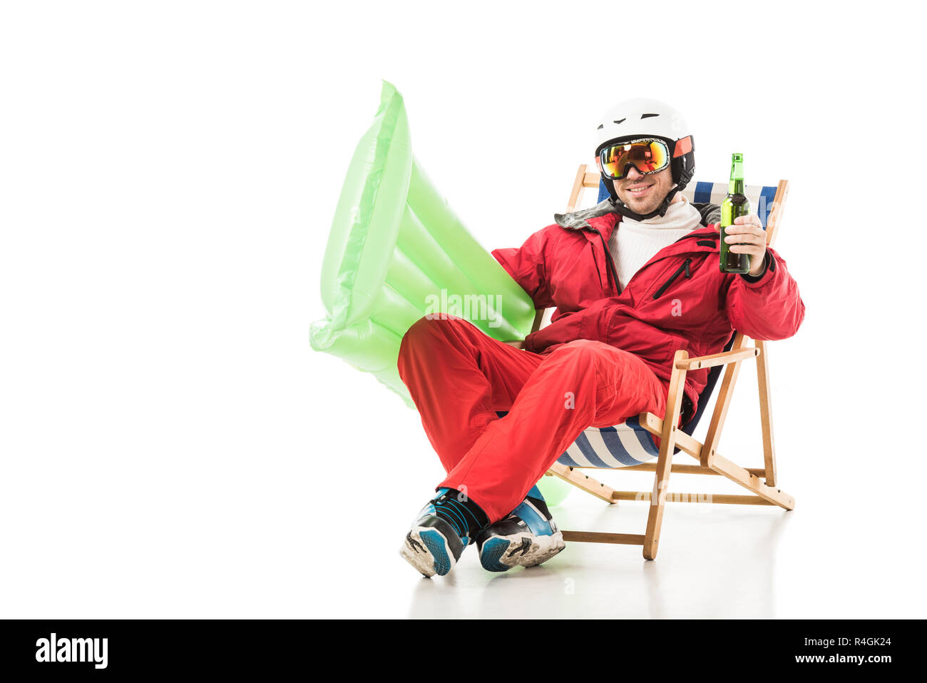 man in ski clothes with beer bottle and pool mattress sitting in deck chair and smiling isolated on white Stock Photo