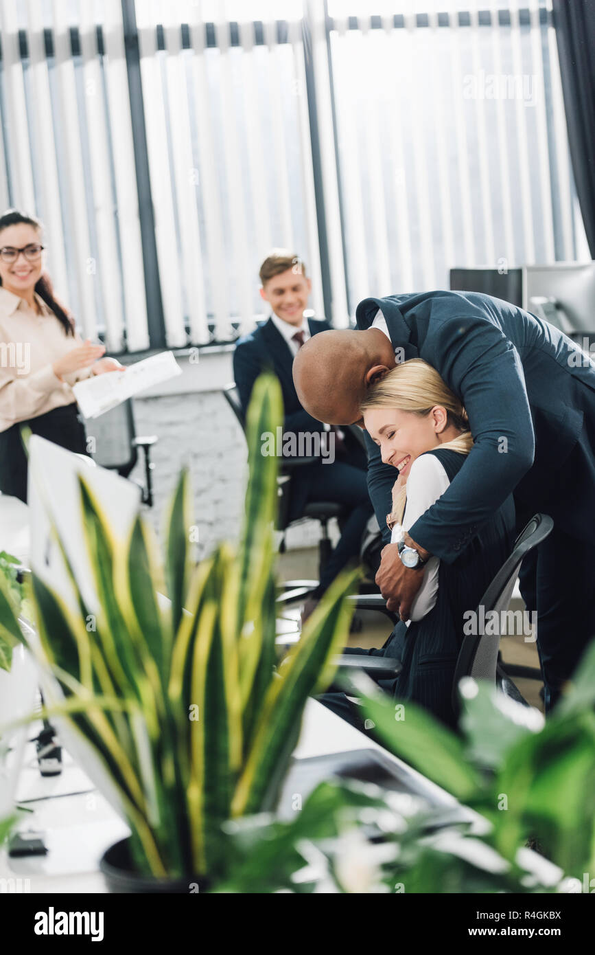 Coworkers hugging hi-res stock photography and images - Alamy
