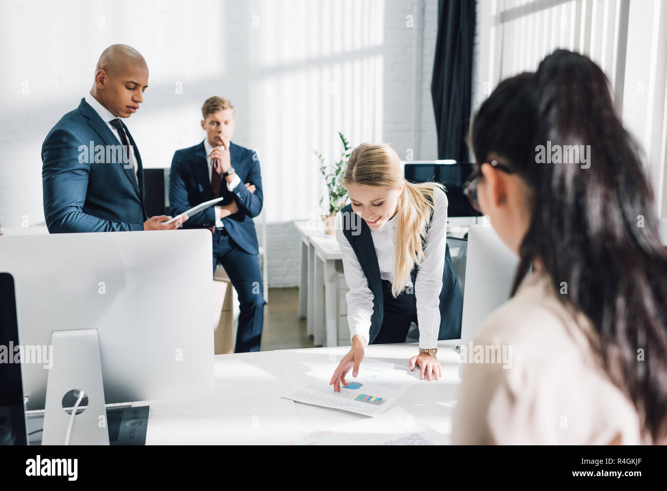 focused young multiethnic business people working together in open ...