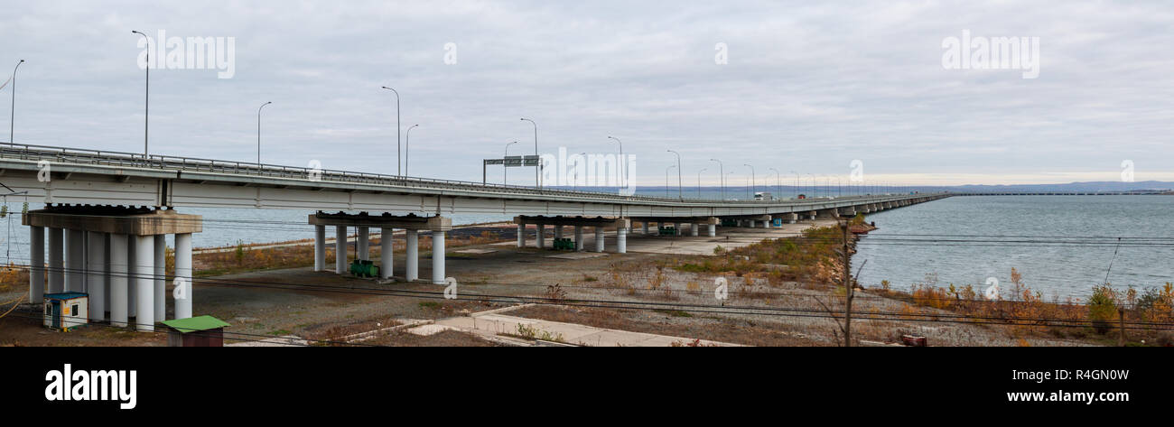 Low water bridge from Sedanka to the De Friz peninsula across the Amur Bay of Primorsky Krai Russia. Far Eastern landscape. Stock Photo