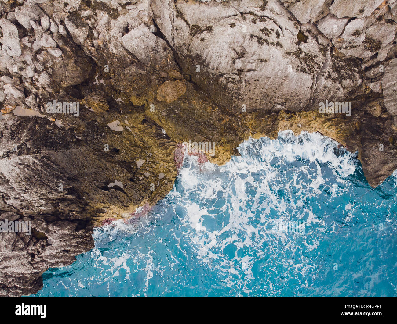Aerial top view of sea waves hitting rocks Stock Photo - Alamy