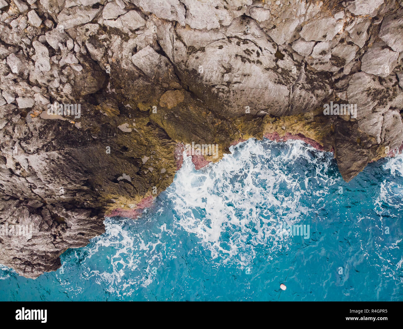 Aerial top view of sea waves hitting rocks Stock Photo - Alamy