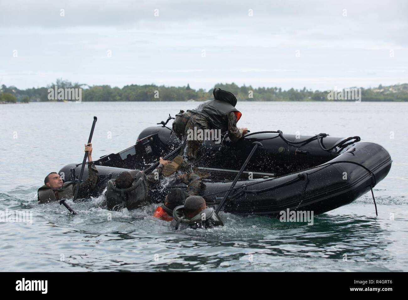 U.S. Marines and Sailors, with Task Force Koa Moana, flip a French Army
