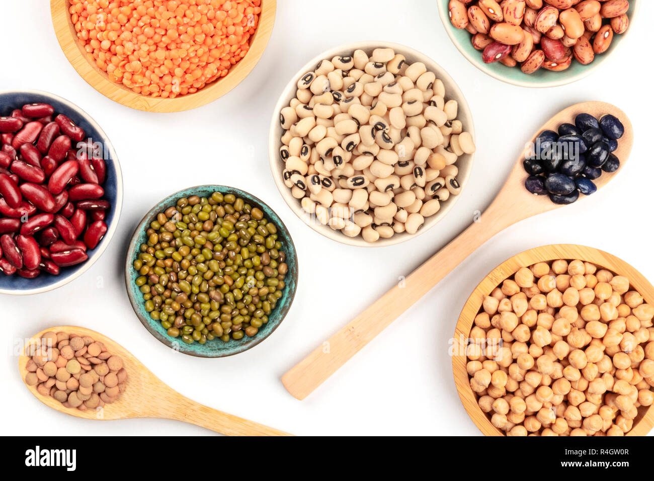 Various types of legumes, shot from above on a white background. Red