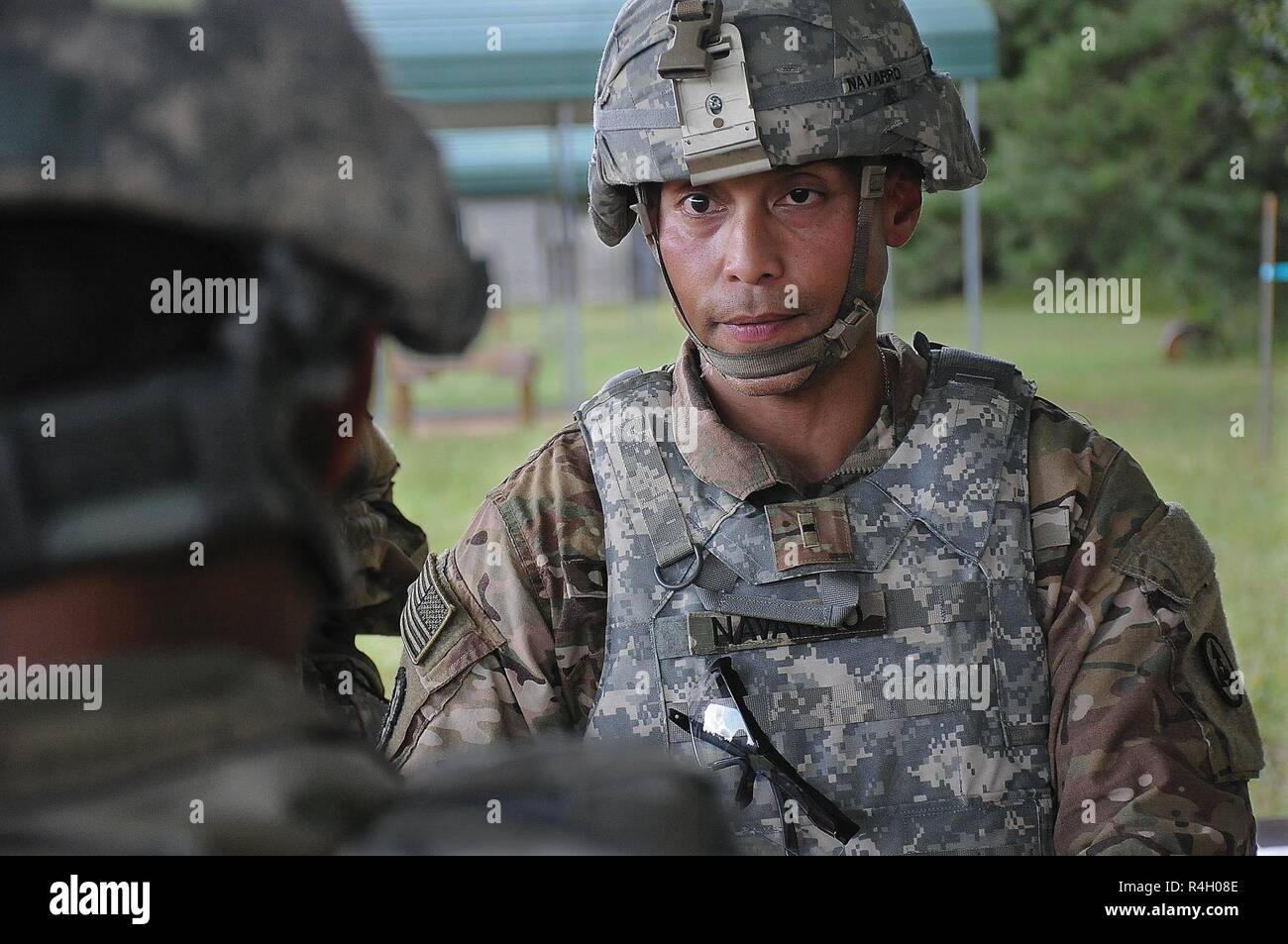 Warrant Officer 1 Raymond Navarro, 3rd Expeditionary Sustainment Command, Fort Bragg, N.C., listens to one of his Soldiers during the ammunition transfer and holding point event Team of the Year Competition Sept. 25 at Fort Pickett. Navarro said he does not have subordinate Soldiers at his home station and taking on the ATHP competition was a means to give back and make it a valuable experience for his team members. Stock Photo