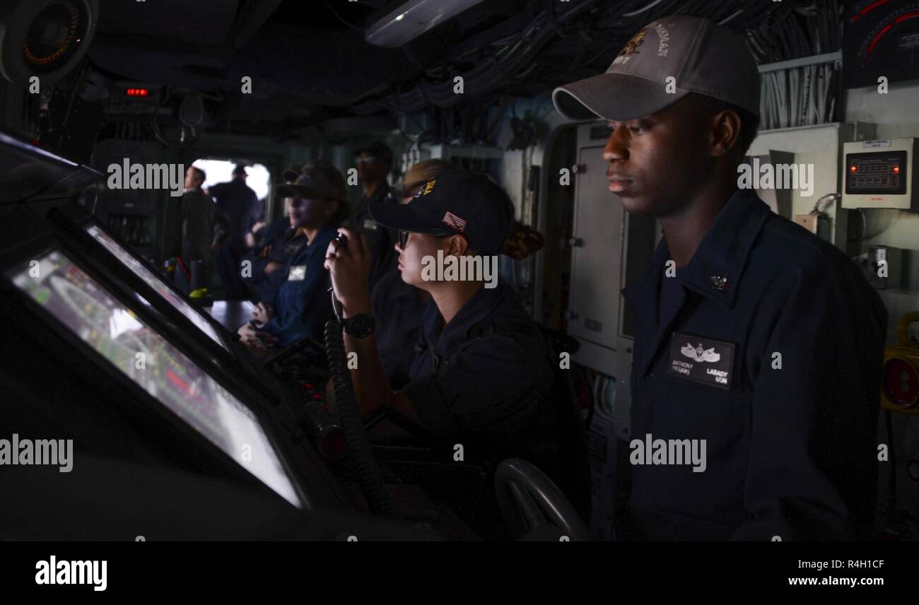 MAYPORT, Fla (September 27, 2018) Seaman Nikkilehn Rae Lim, left, stands lee helmsman watch and Yeoman 3rd Class Anthony Labady stands helmsman watch on the bridge of the Wasp-class amphibious assault ship USS Iwo Jima (LHD 7) while departing Naval Station Mayport, September 27, 2018. Iwo Jima recently departed its homeport of Naval Station Mayport following the completion of a scheduled continuous maintenance availability. Stock Photo