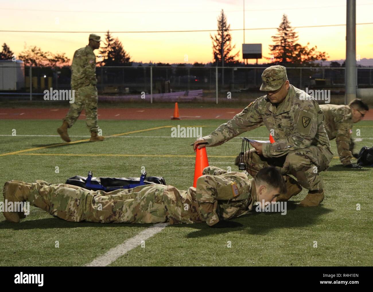 Sgt. 1st Class Luis Ramirez, an operations NCO with 42nd Military Police Brigade, grades a competitor on hand release push-ups during the brigade's first quarter Soldier of the Quarter competition on Joint Base Lewis-McChord, Wash. Stock Photo