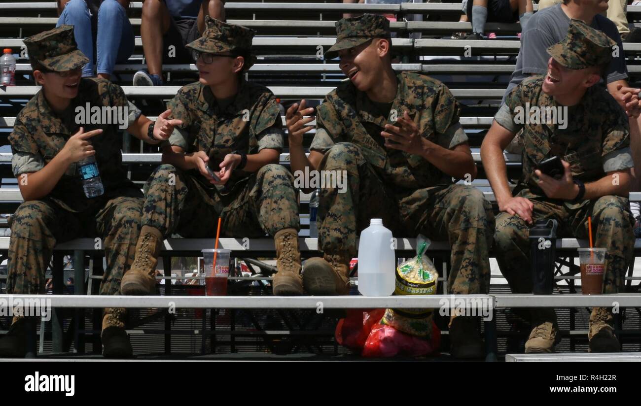 A group of Marines build comradery in the stands before the start of
