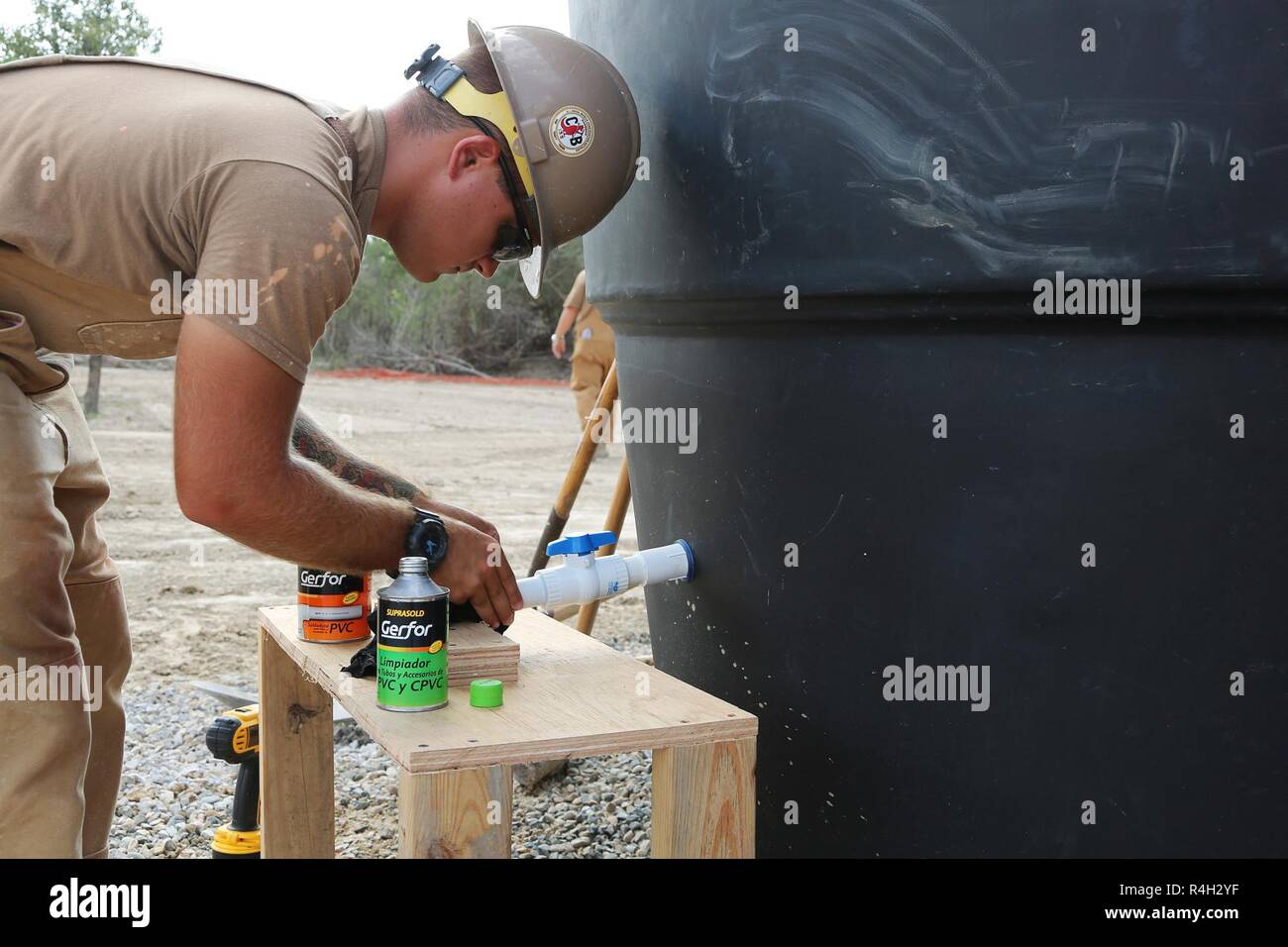 U.S. Navy Utilitiesman 2nd Class Anthony Calleja, assigned to Naval Mobile Construction Battalion (NMCB) 133, assembles the water outlet for the water storage system in Riohacha, Colombia, Sept. 27, 2018, during water-well drilling exploration operations as part of Southern Partnership Station 2018. Southern Partnership Station is a U.S. Southern Command-sponsored and U.S. Naval Forces Southern Command/U.S. 4th Fleet-conducted annual deployment focused on subject matter expert exchanges and building partner capacity in a variety of disciplines including medicine, construction and dive operatio Stock Photo