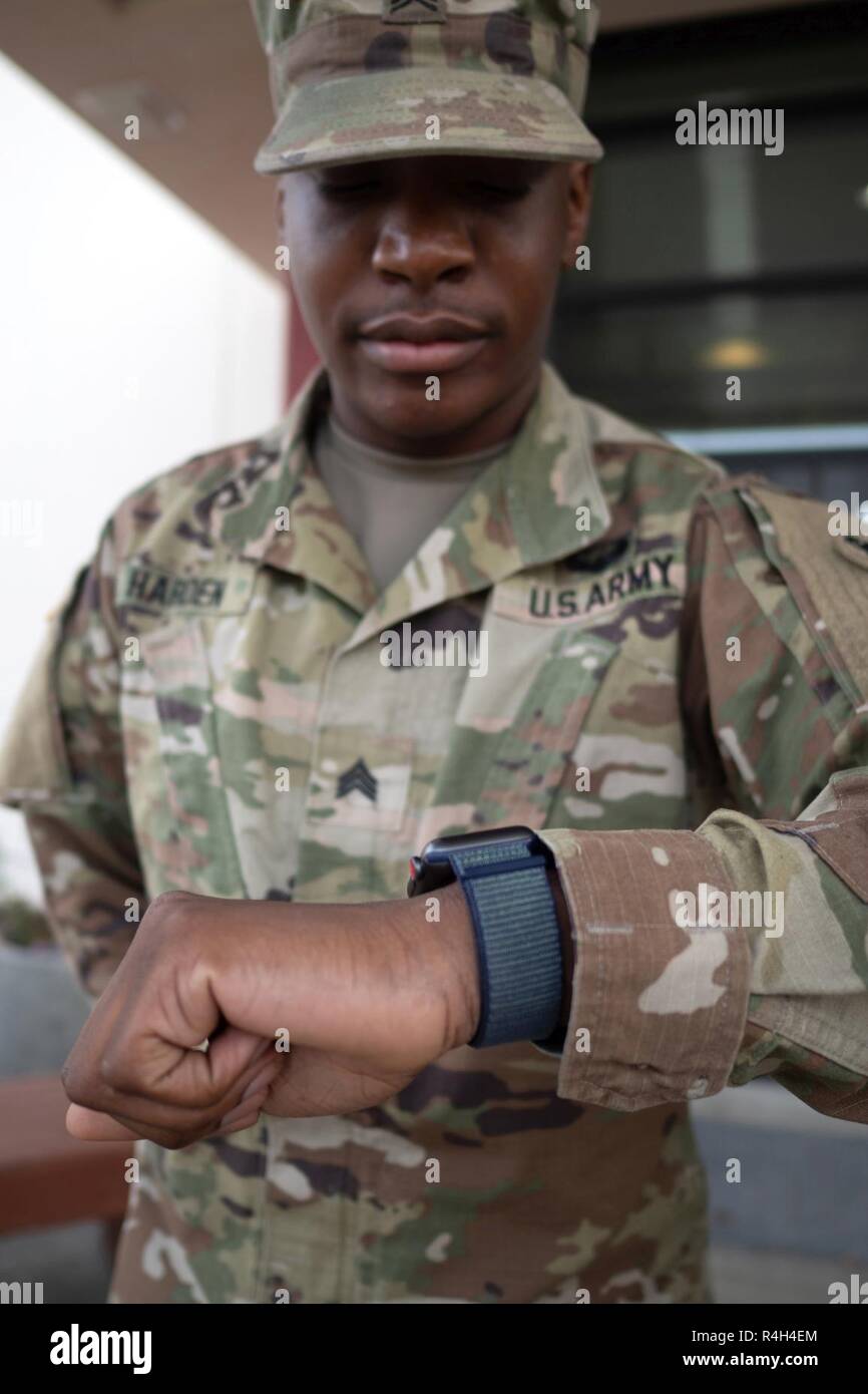 Army Sgt. Mar'Ta Harden, a native of Chicago, Ill., assigned to the 95th  Chemical Company, 17th Combat Sustainment Support Battalion, U.S. Army  Alaska, checks his watch before performing the daily flag retirement