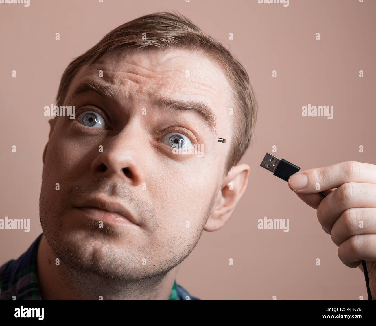 Young man with computer sockets in his head. Selective focus. Stock Photo