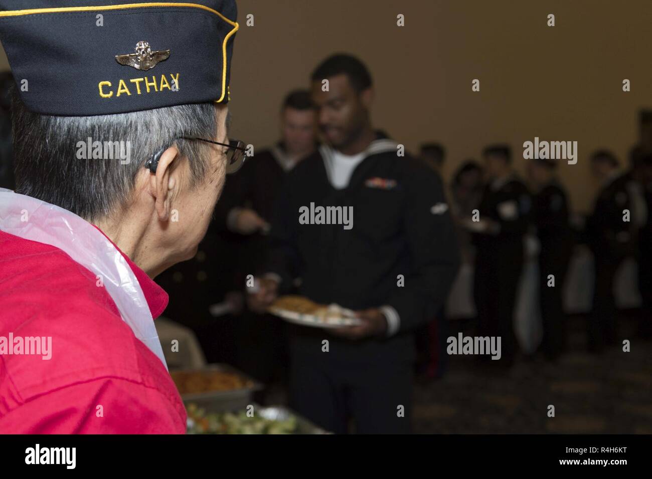 SAN FRANCISCO (Oct. 2, 2018) Members of the American Legion-Cathay Post 384 serve food to Sailors and Marines during their 'Luncheon for the Troops' event held at the San Francisco War Memorial Veterans building during San Francisco Fleet Week  (SFFW) 2018. SFFW is an opportunity for the American public to meet their Navy, Marine Corps and Coast Guard teams and experience America's sea services. During fleet week, service members participate in various community service events, showcase capabilities and equipment to the community, and enjoy the hospitality of San Francisco and its surrounding  Stock Photo