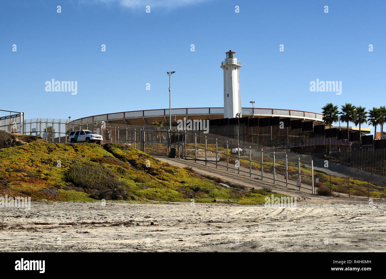 SAN YSIDRO, CALIFORNIA - NOVEMBER 26, 2018: The USA Mexico Border Wall and Border Patrol Vehicle from Imperial Beach looking towards the International Stock Photo