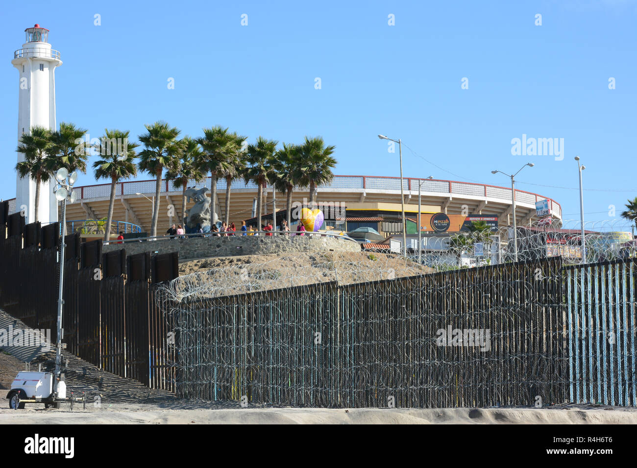 SAN YSIDRO, CALIFORNIA - NOVEMBER 26, 2018: The USA Mexico Border Wall seen from Imperial Beach looking towards Mexico and The Friendship Circle Bi-Na Stock Photo