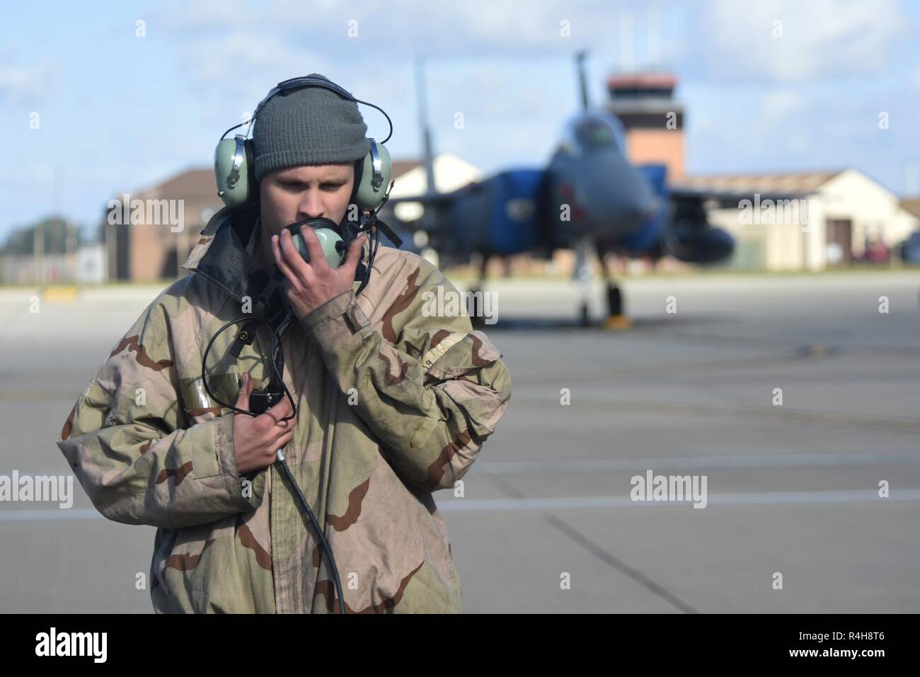 An Airman assigned to the 492nd Fighter Squadron communicates with pilots before departure during the “FURIOUS 48” readiness exercise at Royal Air Force Lakenheath, England, Oct. 1, 2018. Exercises like this provide both aircrew and support personnel stationed at RAF Lakenheath the experience needed to maintain a ready force capable of ensuring the collective defense of the NATO alliance. Stock Photo