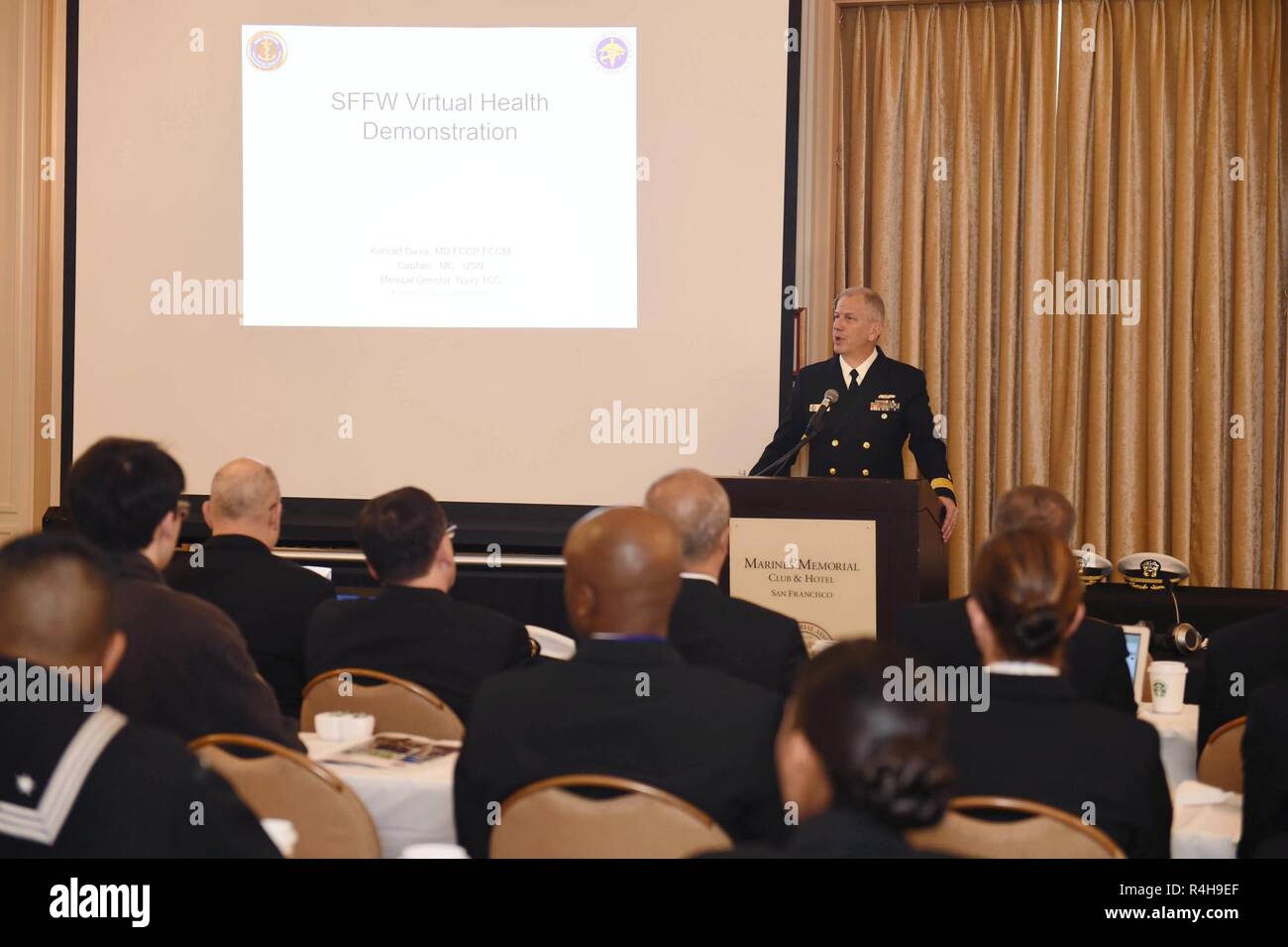 SAN FRANCISCO (Oct. 3, 2018) Rear Adm. Paul D. Pearigen, Commander, Navy Medicine West, addresses local emergency responders and medical professionals prior to begining a tele-medicinal training exercise held at the Marines' Memorial Club during San Francisco Fleet Week (SFFW) 2018. SFFW is an opportunity for the American public to meet their Navy, Marine Corps and Coast Guard teams and experience America's sea services. During fleet week, service members participate in various community service events, showcase capabilities and equipment to the community, and enjoy the hospitality of San Fran Stock Photo