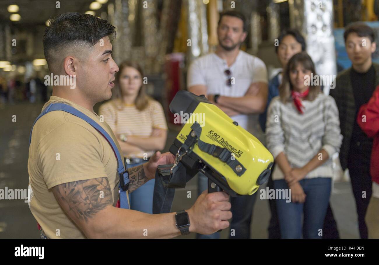 SAN FRANCISCO (Oct. 3, 2018) Damage Controlman 2nd Class Joseph Gonzales showcases firefighting gear as part of a public ship tour of the Independence-variant littoral combat ship USS Manchester (LCS 14) during San Francisco Fleet Week (SFFW) 2018. SFFW is an opportunity for the American public to meet their Navy, Marine Corps and Coast Guard teams and experience America's sea services. During fleet week, service members participate in various community service events, showcase capabilities and equipment to the community, and enjoy the hospitality of San Francisco and its surrounding areas. Stock Photo
