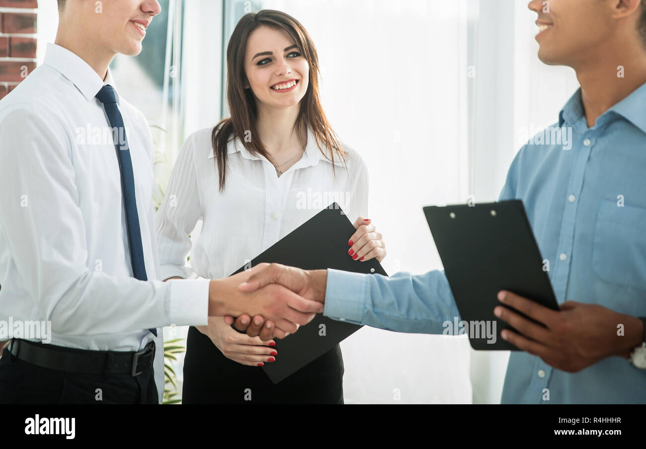 handshake of young business partners in the office Stock Photo - Alamy