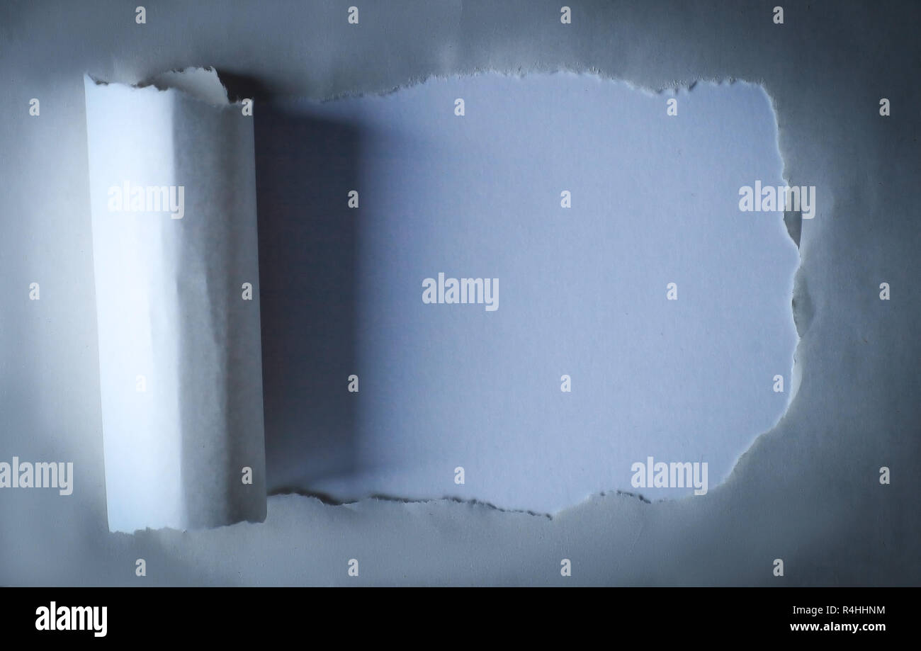 hole in the paper with torn edges.background. Stock Photo
