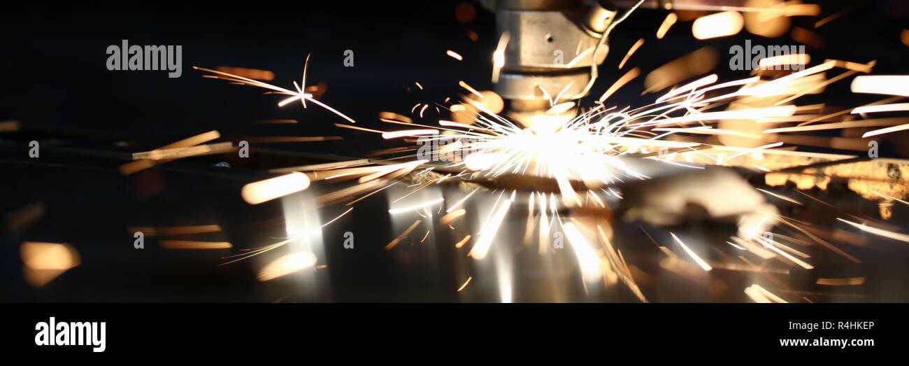 Sparks fly out machine head for metal processing Stock Photo