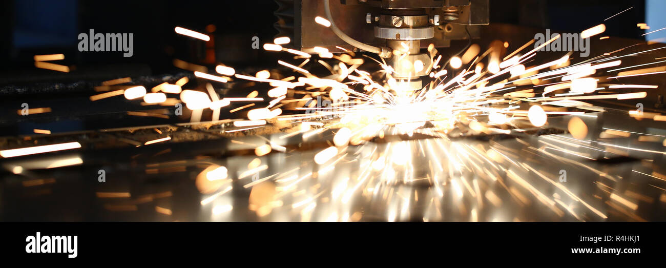 Sparks fly out machine head for metal processing Stock Photo