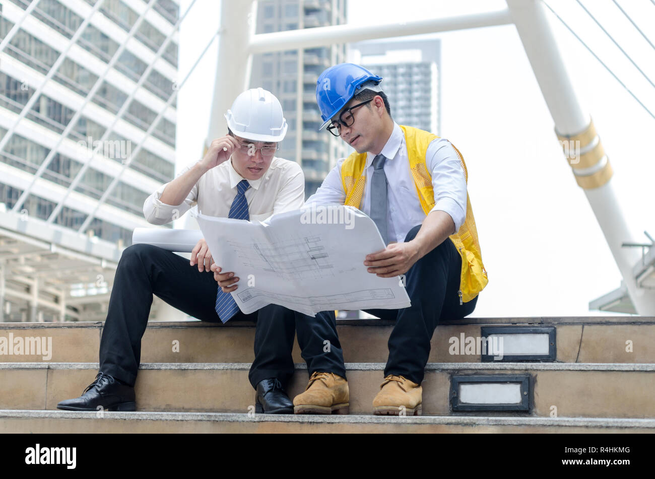 Two asian architects discussing about new project. Stock Photo