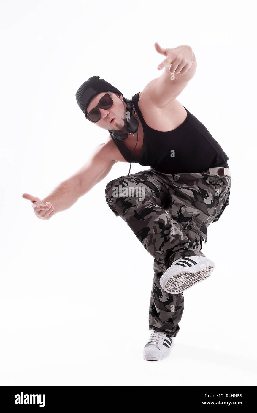 in full growth.Studio portrait of a tough rapper in sunglasses .isolated on white Stock Photo