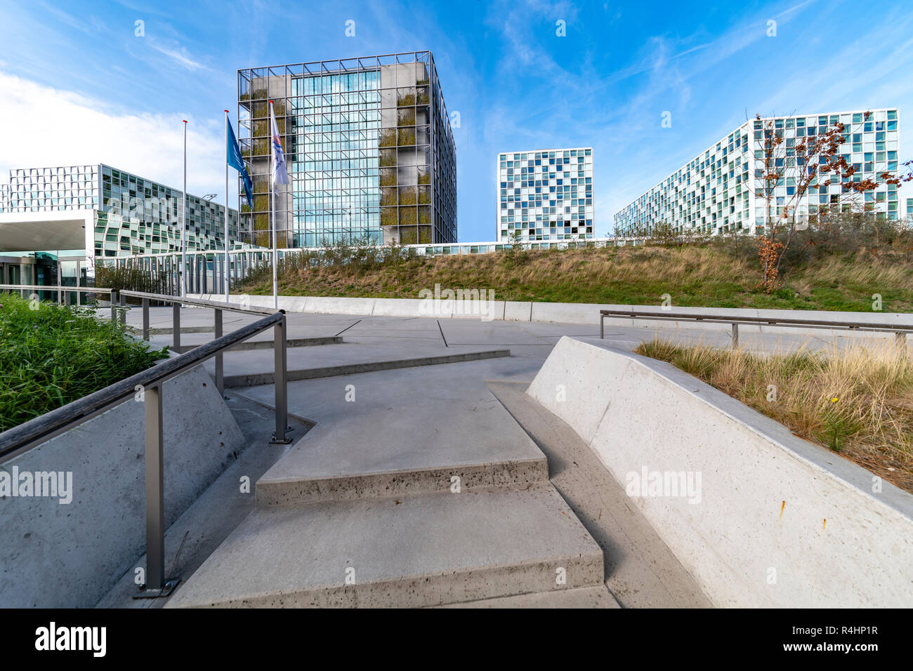 THE HAGUE, 17 October 2018 - Entrance and main gate of the International Criminal Court building under a sunny and blue autumn sky behind a dune with  Stock Photo