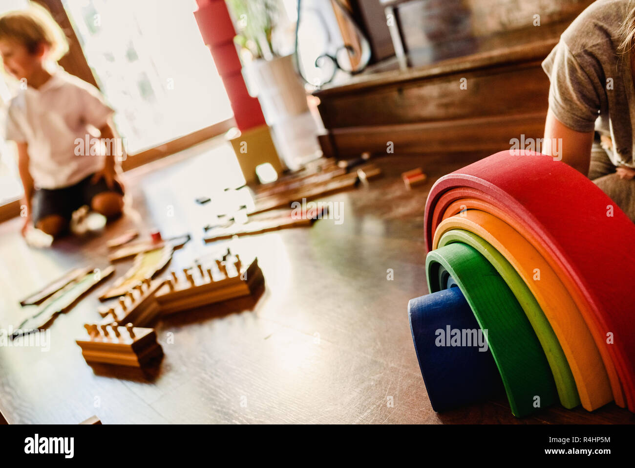 Children playing with wooden rainbow waldorf montessori Stock Photo - Alamy