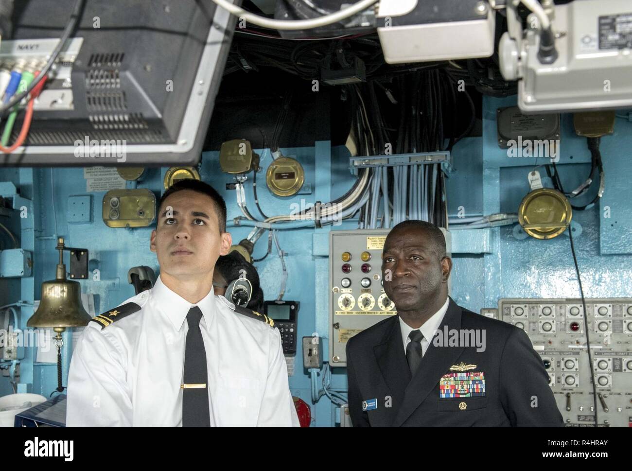 BALTIMORE (Oct. 3, 2018) Rear Adm. Stephen Evans, right, Commander, Carrier Strike Group Two, observes Lt. j.g. Thomas Mickelson, from San Diego, navigating aboard the Harpers Ferry-class dock landing ship USS Oak Hill (LSD 51) during Maryland Fleet Week and Air Show Baltimore. MDFWASB is Baltimore’s celebration of the sea services and provides an opportunity for the citizens of Maryland and the city of Baltimore to meet Sailors, Marines and Coast Guardsmen, as well as see firsthand the latest capabilities of today’s maritime services. Stock Photo