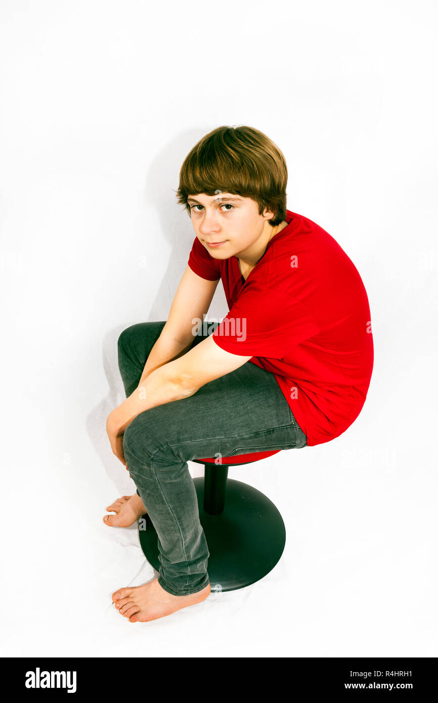 teenage boy sitting on a chair Stock Photo Alamy