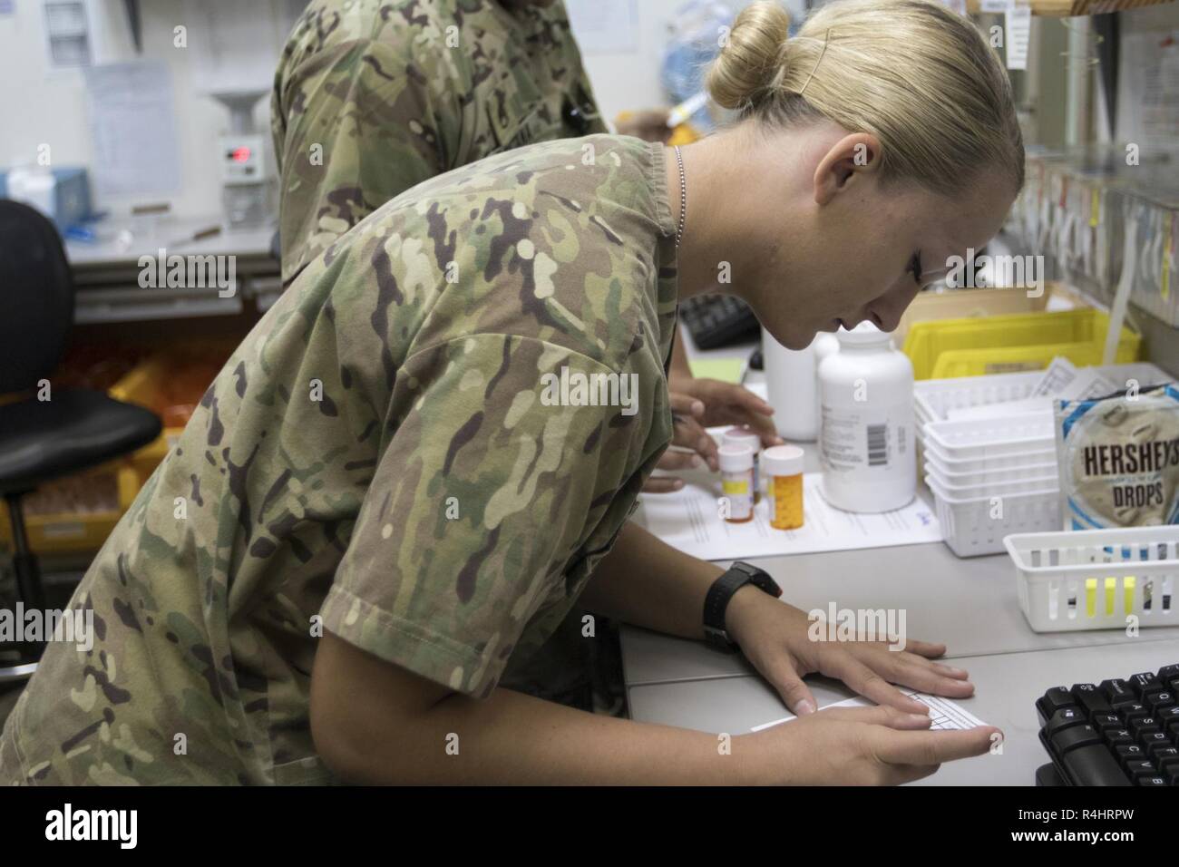 U.S. Army Pvt. 1st Class Jenna Van Horn, a pharmacy specialist with the 452nd Combat Support Hospital, prepares a prescription for a patient at the 452nd CSH, Camp Arifjan, Kuwait, Oct. 3, 2018. The work done by Soldiers in the  452nd CSH ensures that service members stationed in Central Command's area of responsibility remain healthy and capable of accomplishing their mission. Stock Photo