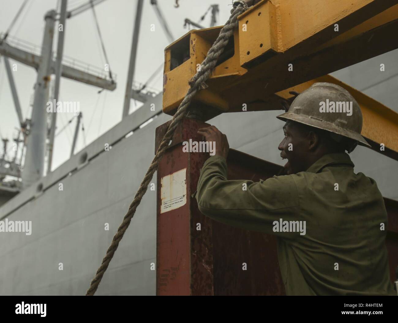 A U.S. Marine with II Marine Expeditionary Force prepares to attach a truck lift to a vehicle carrier in order to maneuver the carrier on the deck of USNS Wright (T-AVB 3) prior to embarkation to Norway in the Port of Morehead City in Beaufort, N.C., Sept. 28, 2018. These vehicles will be used as part of II MEFs participation in the NATO-led Exercise Trident Juncture 18 in Norway, Sweden, Finland, and Iceland. Trident Juncture 18 enhances the U.S. and NATO Allies’ abilities to work together collectively to conduct military operations under challenging conditions. Trident Juncture will include  Stock Photo