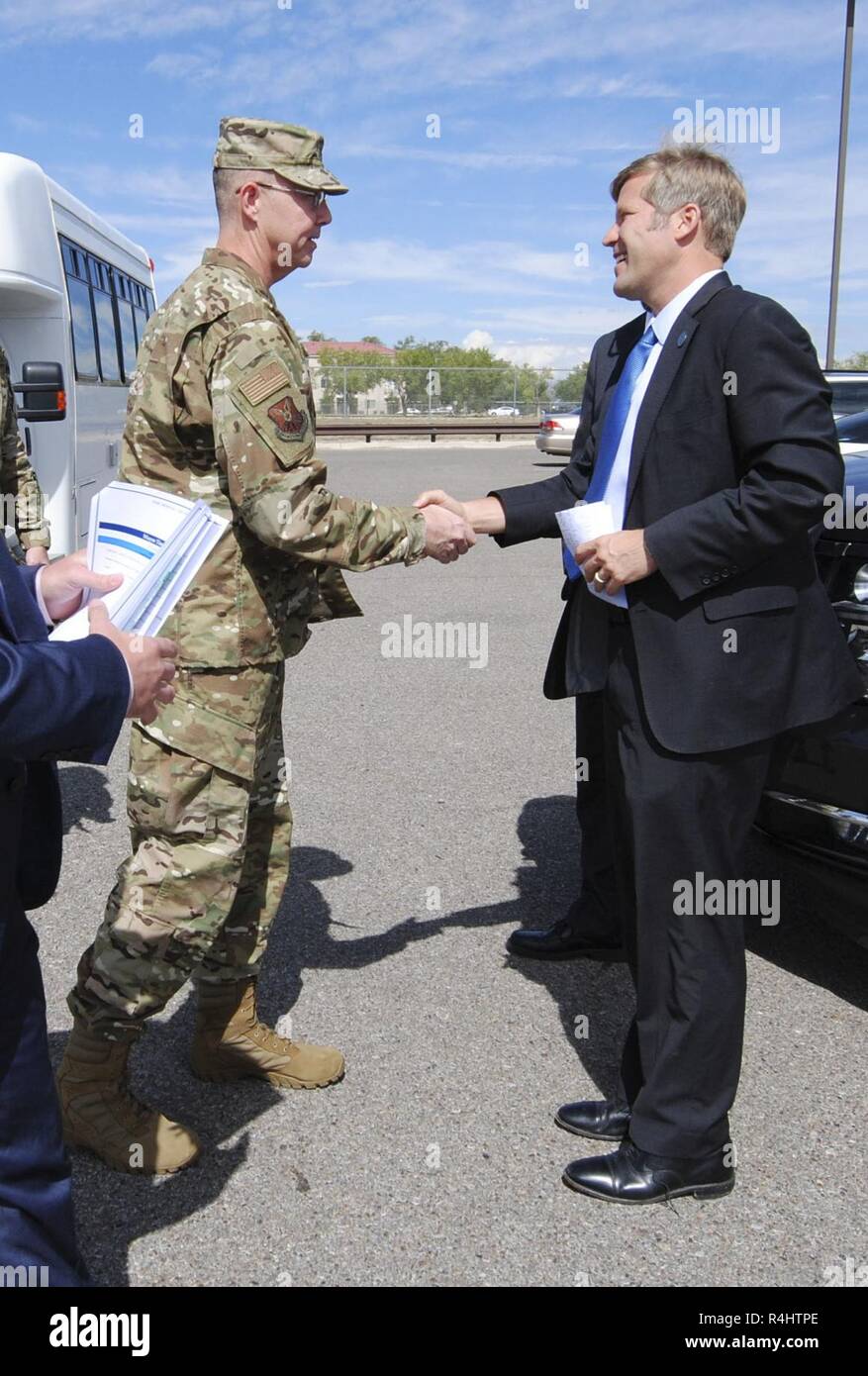 U.S. Air Force Col. Richard Gibbs, 377th Air Base Wing commander, shakes hands with Tim Keller, Albuquerque mayor, at Kirtland Air Force Base, N.M., Oct. 2, 2018. Keller visited Kirtland as part of an immersion tour. Stock Photo