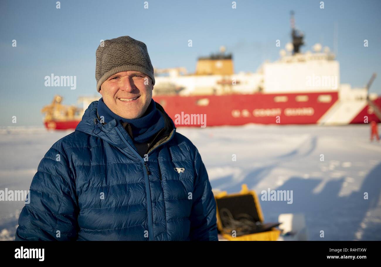 ARCTIC OCEAN – Jason Gobat of the Applied Physics Laboratory at the University of Washington, Seattle, poses for a photo Wednesday, Oct. 3, 2018, about 715 miles north of Barrow, Alaska.  Gobat is the lead engineer who designed, built and programmed a series of sea gliders, which are autonomous submarines used to measure water conductivity, temperature, depth, oxygen and other measurements in the Arctic Ocean. Once deployed, the sea gliders are controlled by pilots at the Applied Physics Lab at the University of Washington in Seattle. Approximately 30 scientists are aboard the Healy to study s Stock Photo