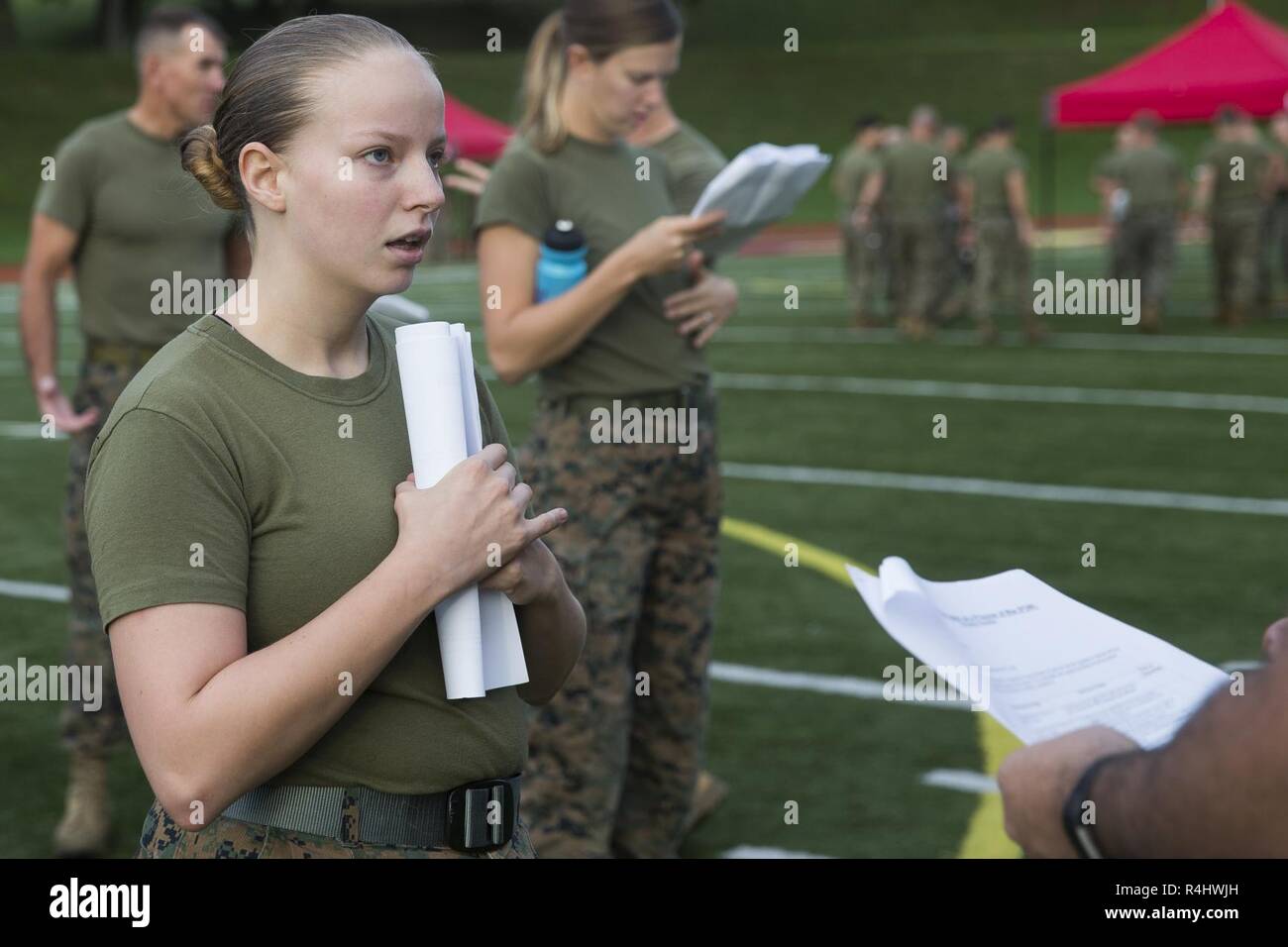 A U.S. Marine answers questions from the Battle Skills Test (BST) at Butler Stadium, Marine Corps Base Quantico, Va. Sept. 23, 2018. The BST is a program that consists of 30 tasks. The tasks are derived from entry-level training such as boot camp, Marine Combat Training or Infantry Training Battalion. Stock Photo
