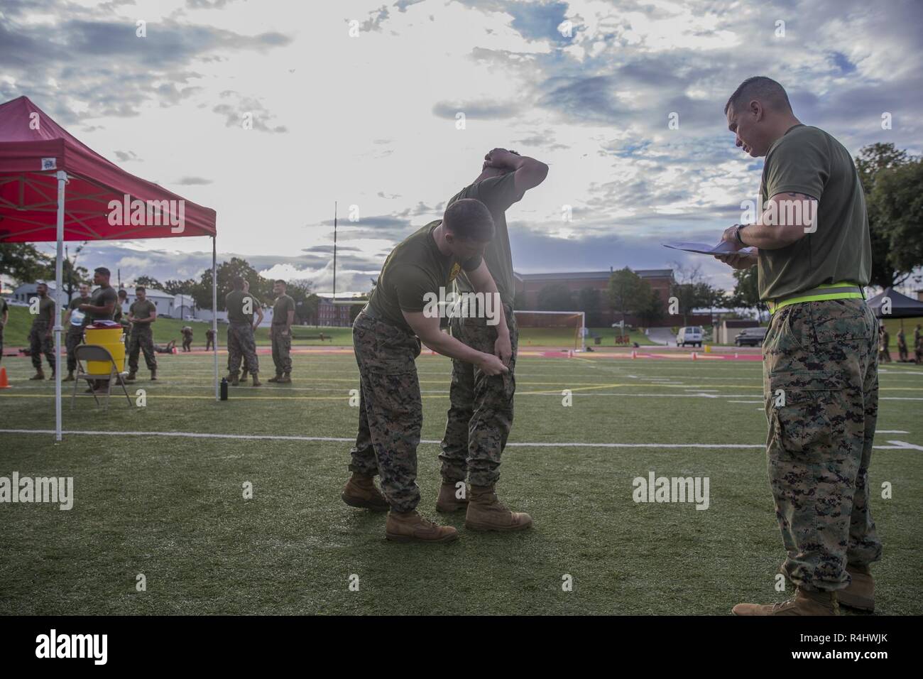 A U.S. Marine pats down another Marine for weapons as part of the Battle Skills Test (BST) at Butler Stadium, Marine Corps Base Quantico, Va. Sept. 23, 2018. The BST is a program that consists of 30 tasks. The tasks are derived from entry-level training such as boot camp, Marine Combat Training or Infantry Training Battalion. Stock Photo