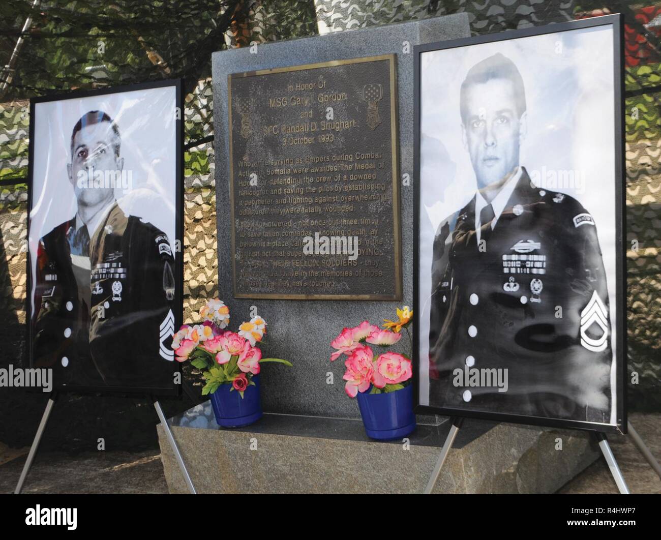 Large portraits of Sgt. 1st Class Randall D. Shughart (left) and Master Sgt. Gary I. Gordon flank the plaque that synopsizes the story of their actions during the Battle of Mogadishu Oct. 3, 1993. Stock Photo