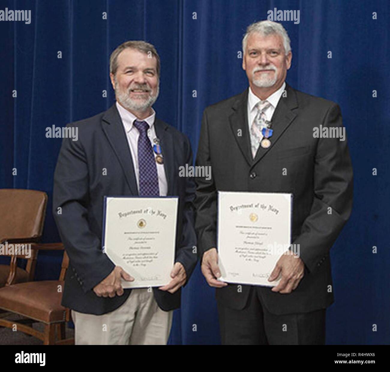 Division Newport employees Thomas Downie and Thomas Floyd (from left) were awarded Department of the Navy Meritorious Civilian Service Awards, the third highest honorary award bestowed by the Navy, during a ceremony on Oct. 1. Stock Photo
