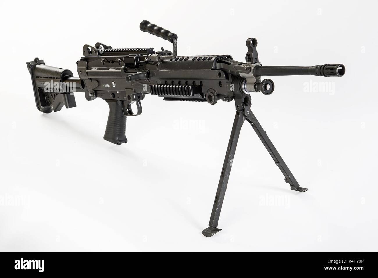 The M249 light machine gun, formerly designated the M249 Squad Automatic Weapon (SAW) and formally written as Light Machine Gun, 5.56 mm, M249, is the American adaptation of the Belgian FN Minimi, a light machine gun manufactured by the Belgian company FN Herstal (FN). The weapon was introduced in 1984 after being judged the most effective of a number of candidate weapons to address the lack of automatic firepower in small units. The M249 provides infantry squads with the high rate of fire of a machine gun combined with accuracy and portability approaching that of a rifle.    The M249 is gas o Stock Photo