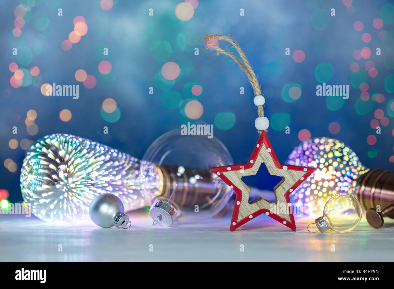 christmas background with retro light lamps, decorative christmas tree balls and wooden star. new year festive background Stock Photo