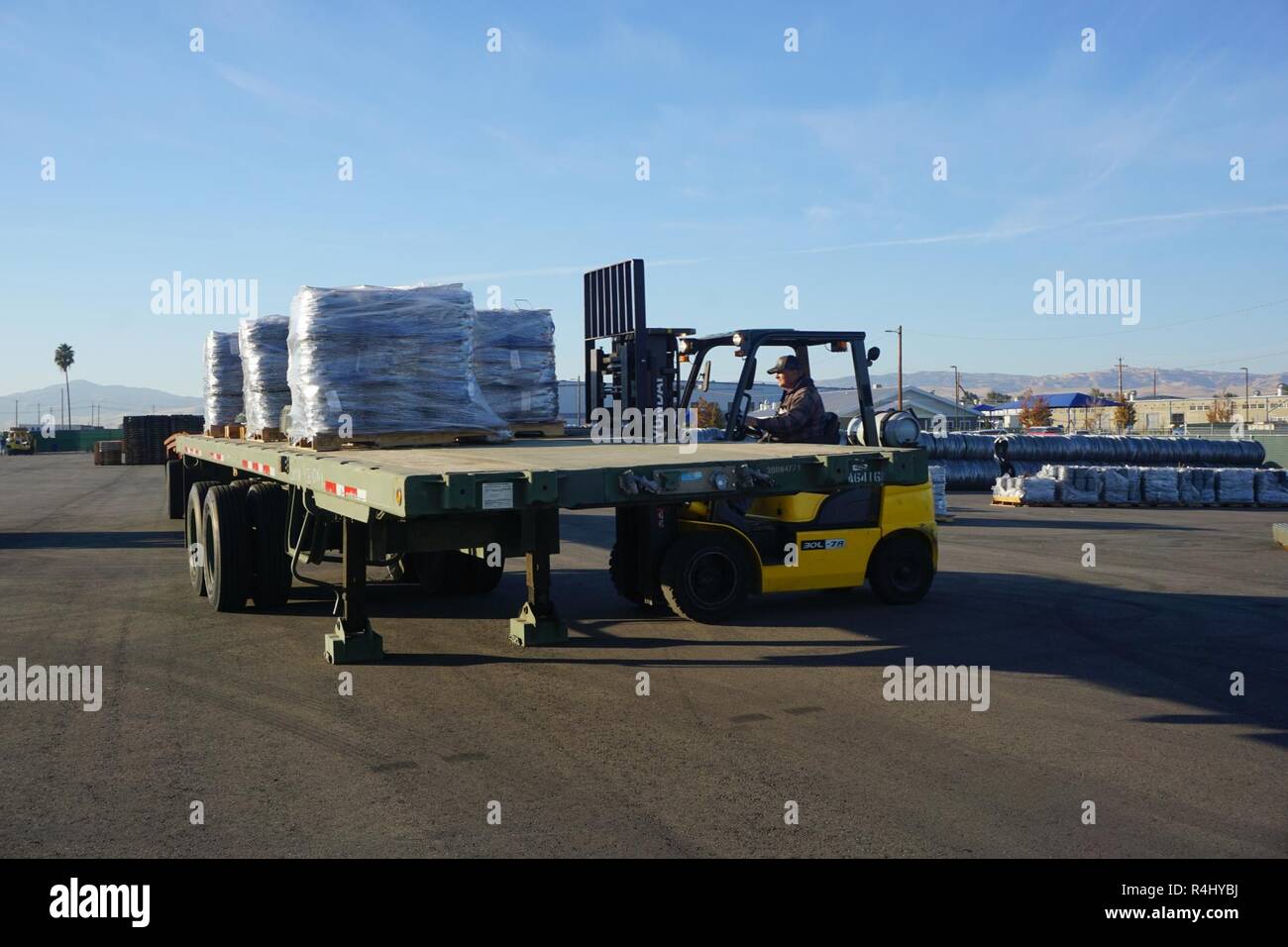 A member of the Bulk Division team is offloading concertina wire that ...