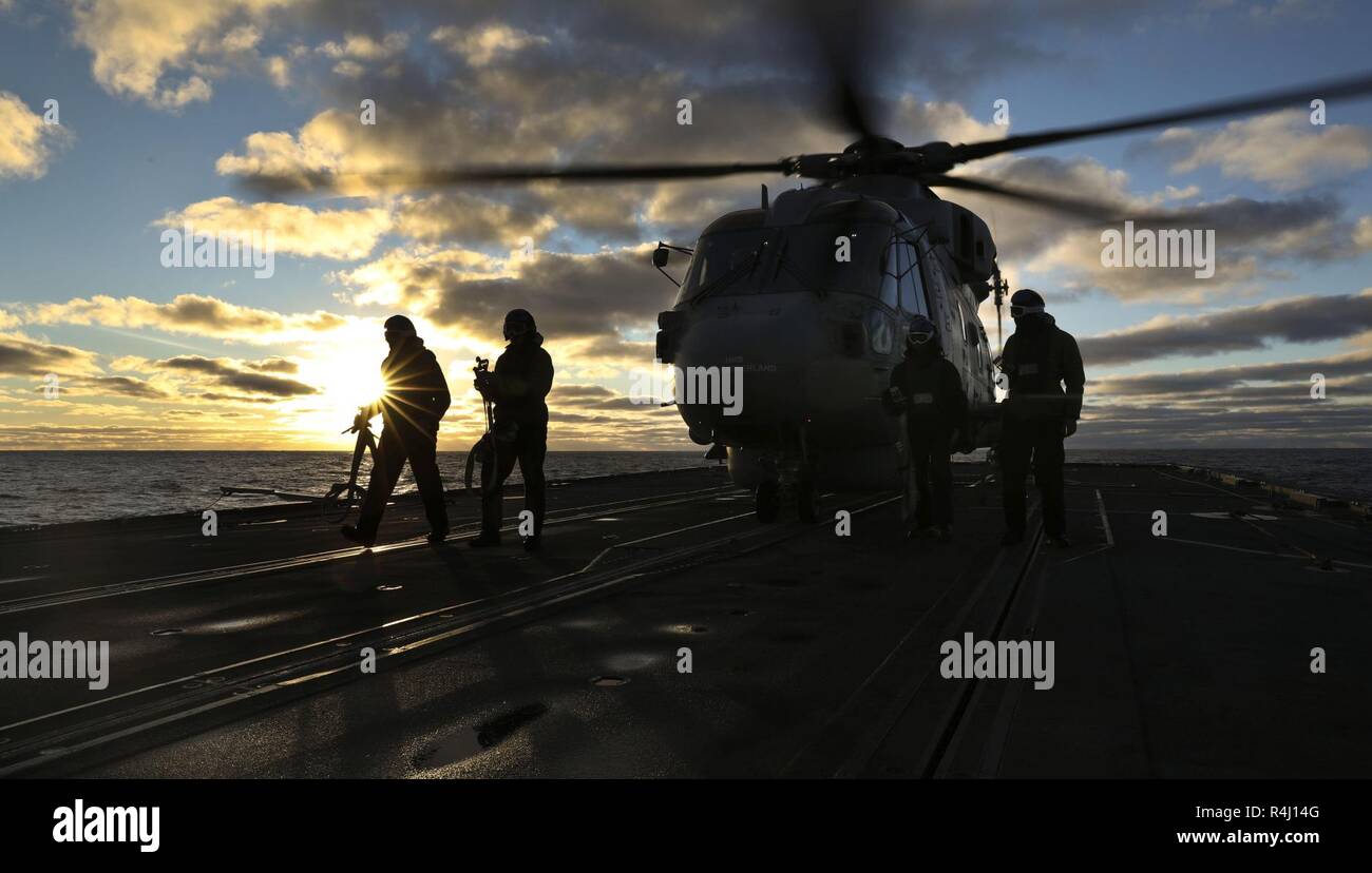 The British Royal Navy Type 23 frigate HMS Northumberland's embarked Merlin Mk2 helicopter operates from the deck of the ship in the North Atlantic off Norway during Exercise Trident Shield 18 Oct. 26, 2018. Excercise Trident Juncture 18 (TRJE18) is the flagship collective defence exercise for NATO and is the biggest in 2018. The  Exercise will take place from 25th October until the 7th November. (Royal Navy Stock Photo