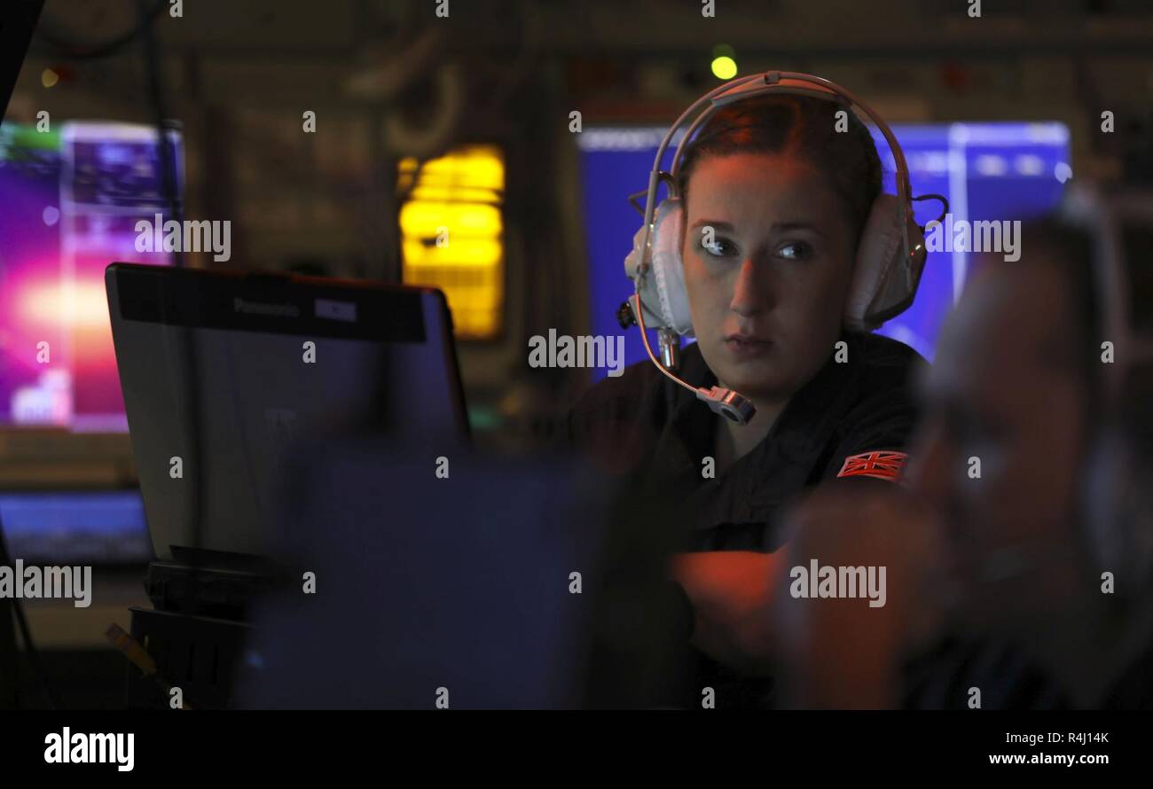 A Royal Navy sailor sits at her console in the operations room of the Type 23 frigate HMS Northumberland during NATO exercise Trident Juncture 2018 on October 26, 2018. The heart of any modern warship the Ops Room is where the sensors and links with other warships and aircraft are coordinated to give a picture of what is happening in the air, on the surface and sub surface. Excercise Trident Juncture 18 (TRJE18) is the flagship collective defence exercise for NATO and is the biggest in 2018. The  Exercise will take place from 25th October until the 7th November. Stock Photo
