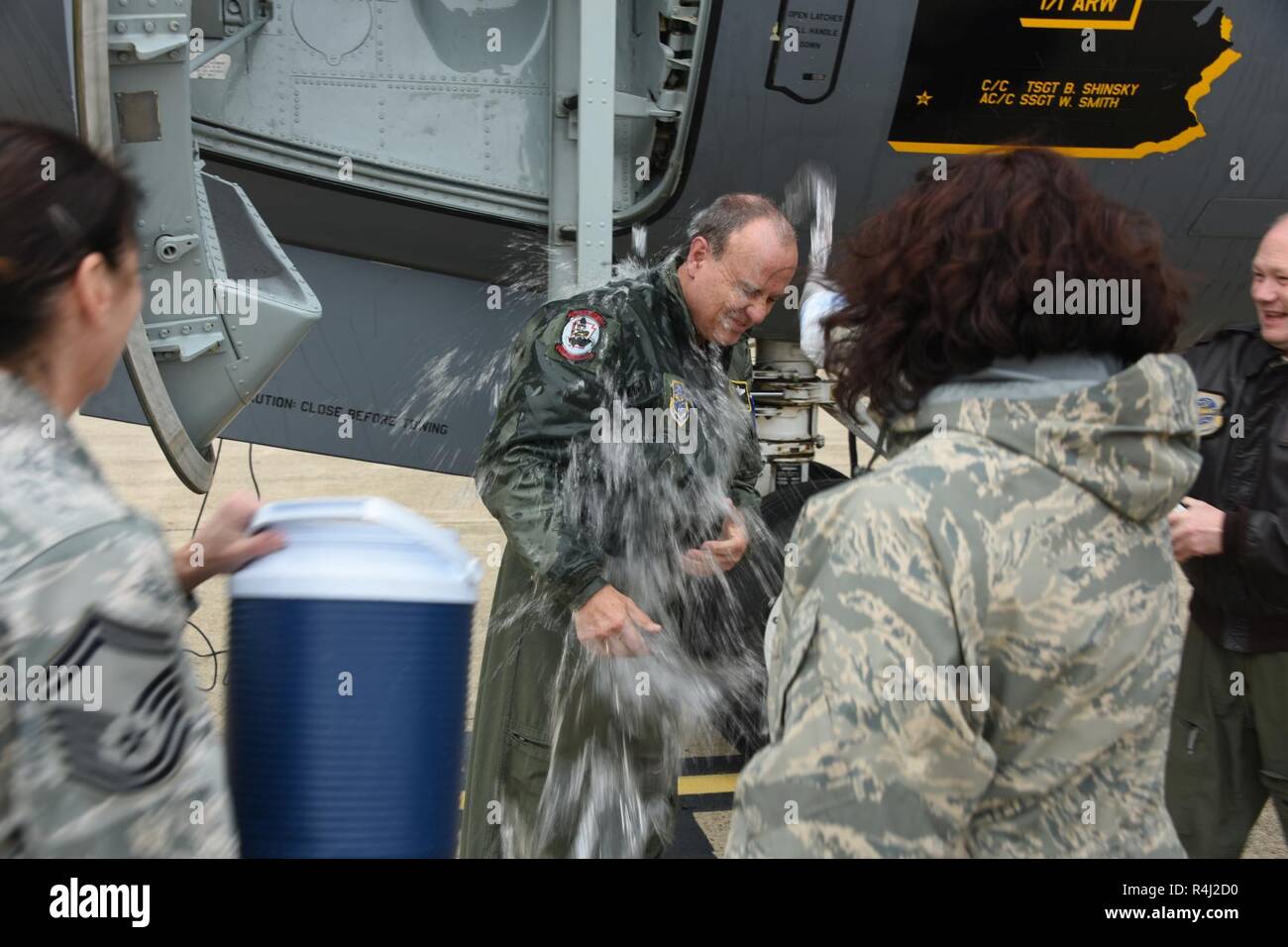 Pennsylvania Air National Guardsman Command Chief Master Sgt. Randy Miller is doused with water by friends in coworkers as he celebrates 39 years of service after his final flight Oct. 26, 2018. Chief Miller retires as the Command Chief Master Sgt. at the 171st Air Refueling Wing where he held that job title since 2011. Chief Miller has over 4300 flight hours. He started his career in the active duty Air Force in 1977 where he served in logistics and postal And in 1983 transferred to the Texas Air National Guard. He took to the sky in 1993 where he trained into the in-flight refueling career f Stock Photo