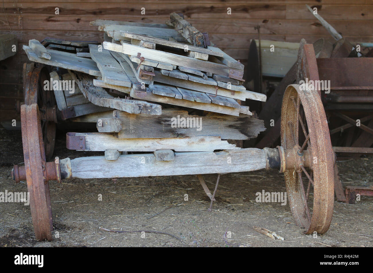 old rickety farm wagon loaded with lumber Stock Photo