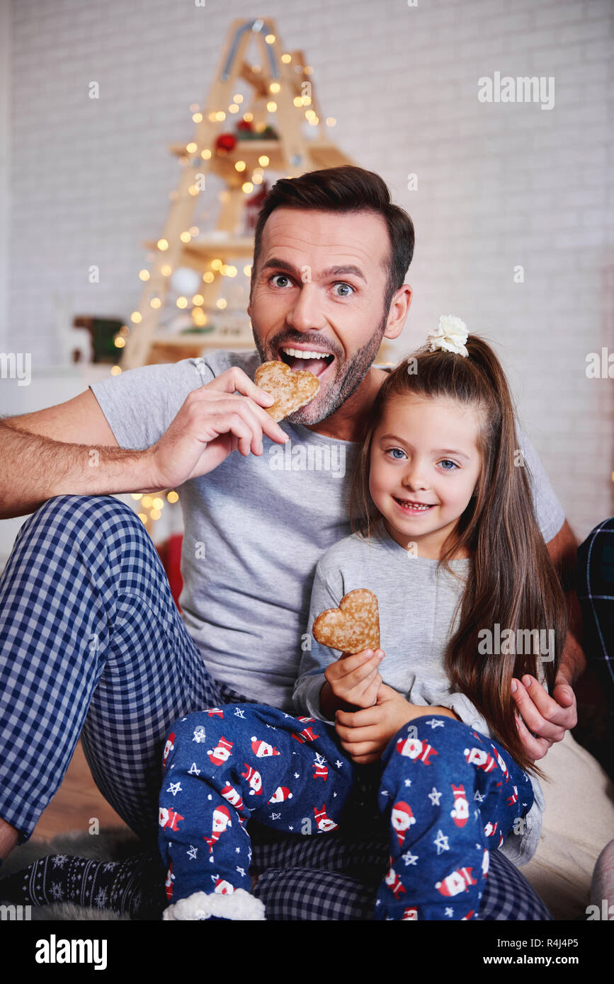 Portrait of father and daughter eating gingerbread Stock Photo